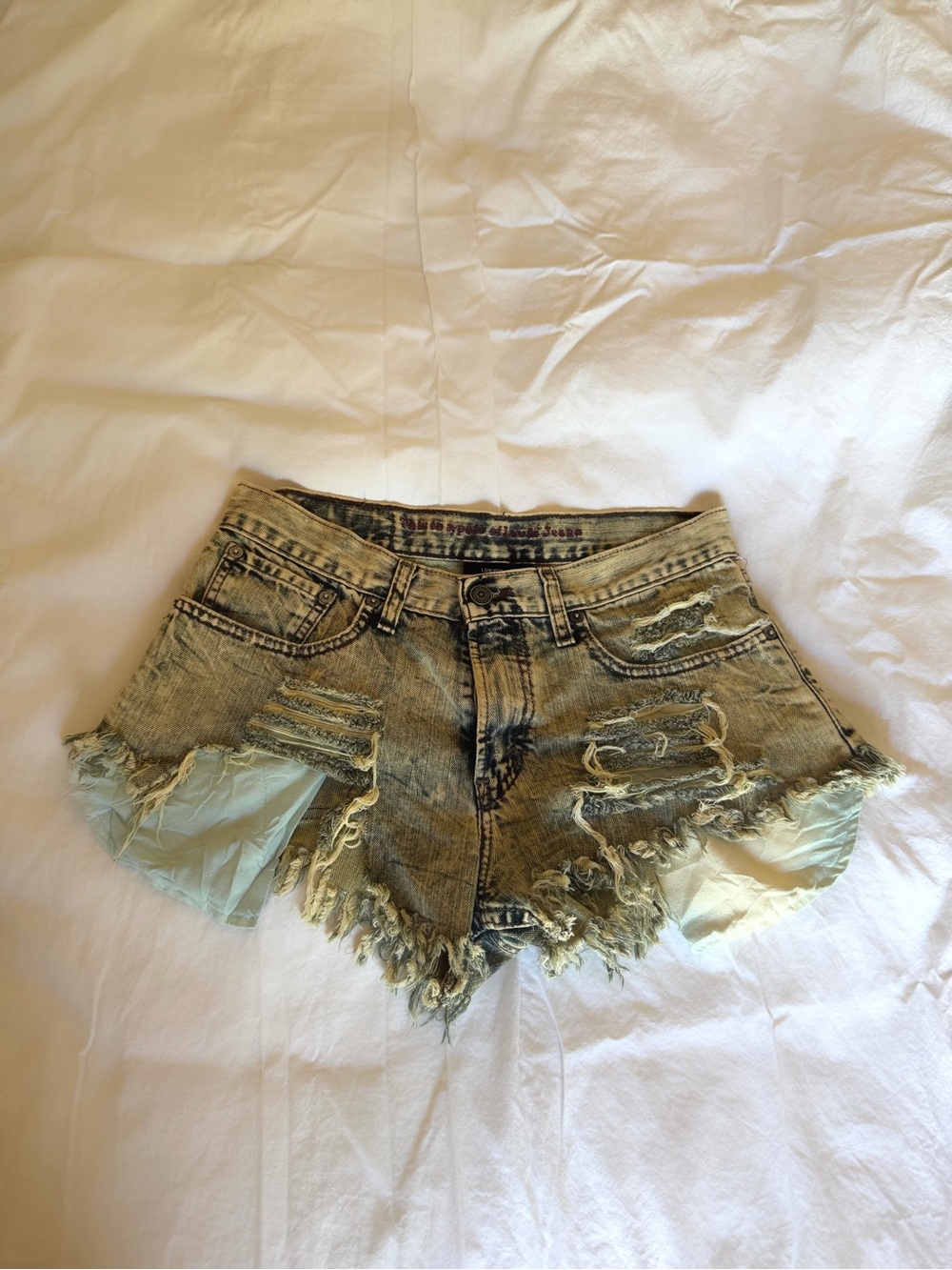 Levi's Distressed Yellow-Tinted Denim Cutoff Shorts